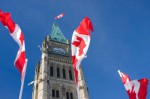 Three Canadian flags fluttering in the wind on Parliament Hill, Ottawa, Canada