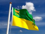 The flag of Saskatchewan blowing against a blue sky