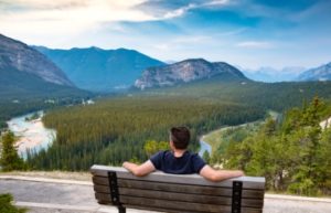 A young man overlooking a valley near Banff, Alberta, Canada 