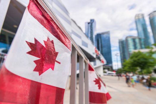 Canada plastic flag with blurred urban background in Toronto