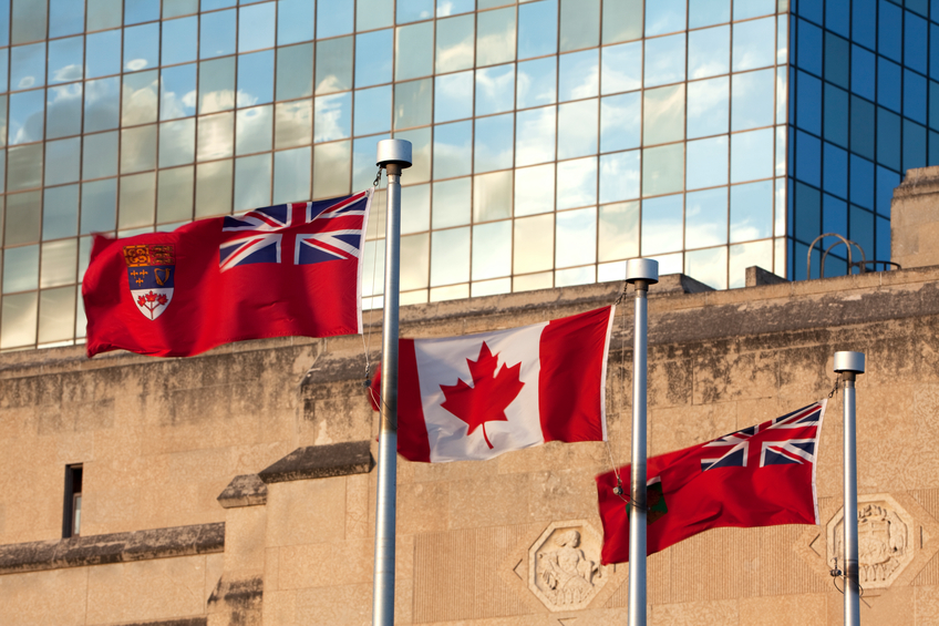 "Manitoba and Canadian flags on Memorial BLVD,Winnipeg, Manitoba. On Memorial blvd are many govertment buildings. Image taken from a tripod."