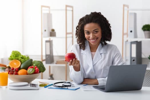 Nutritionist holding an apple