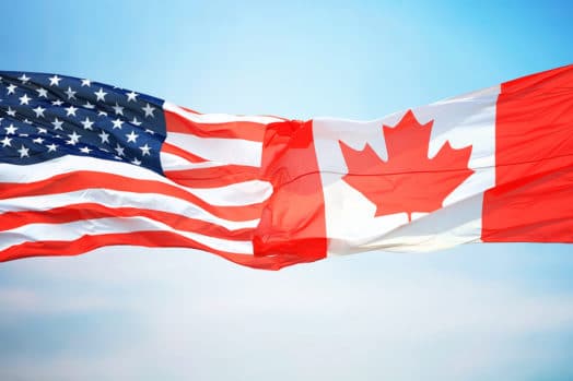 U.S. flag touching Canadian flag