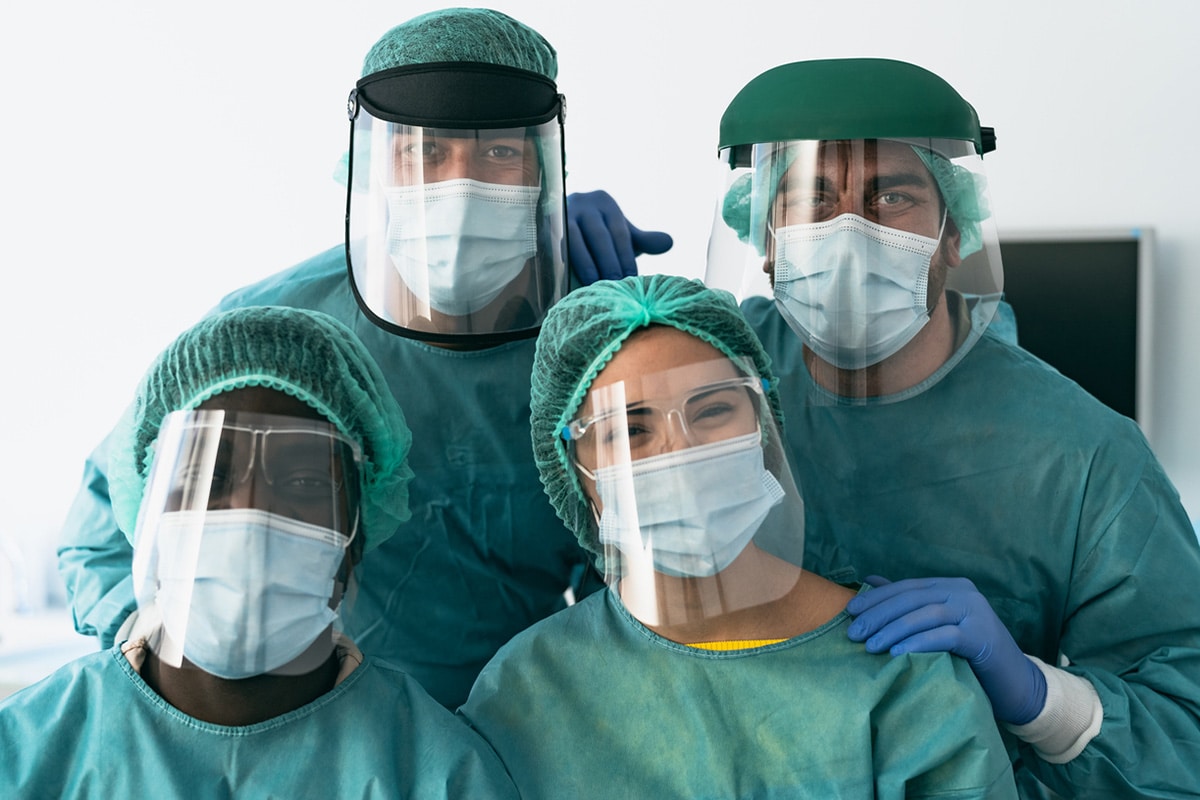 Healthcare workers wearing protective equipment facing camera