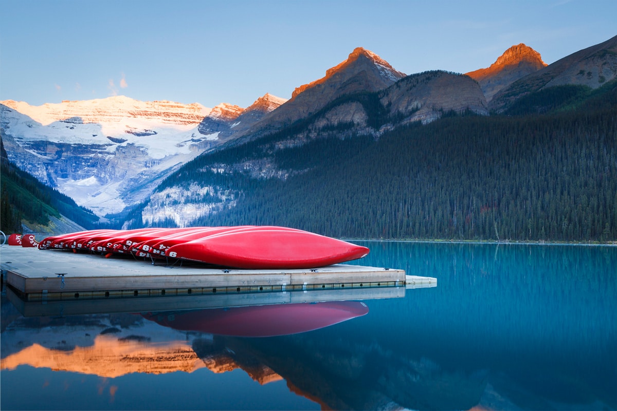 red canoes lined up on Lake Louise dock in Alberta