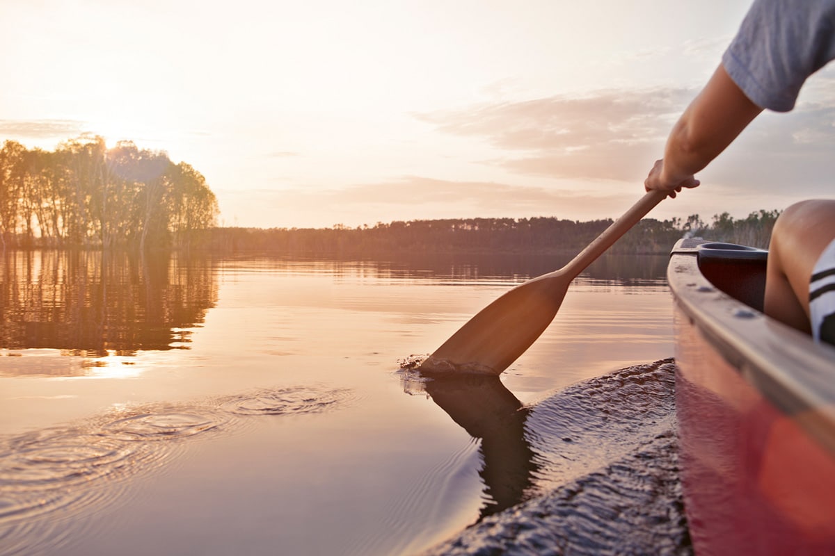 Person canoeing on Jackfish Lake in Manitoba.