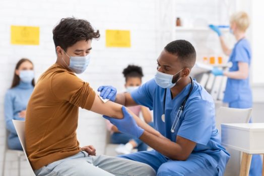 Black male nurse helping patient