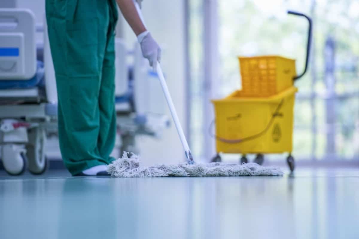 Worker cleaning hospital floor