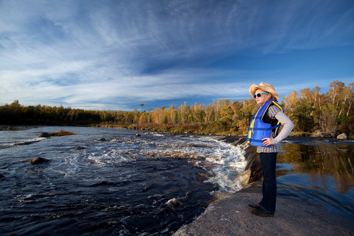 Person standing near waterfalls in Manitoba