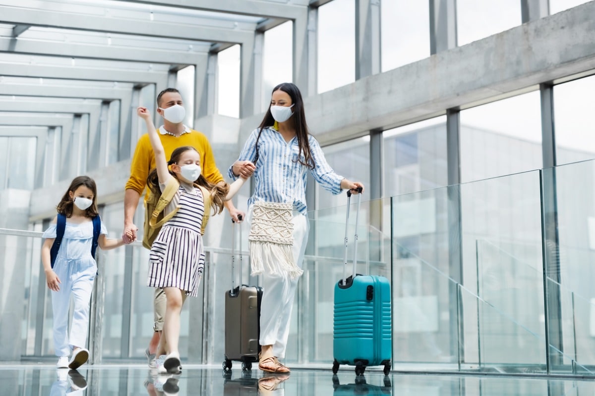 Family at airport wearing surgical masks
