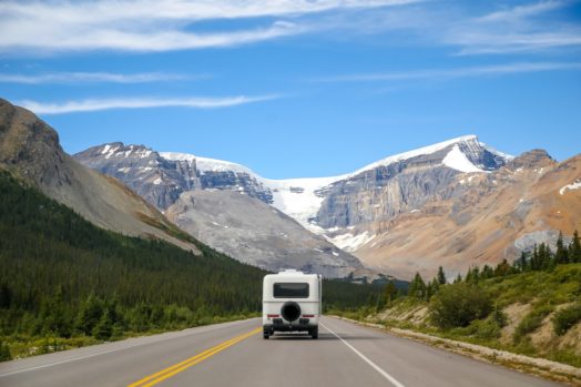 RV driving on road through Canadian mountains