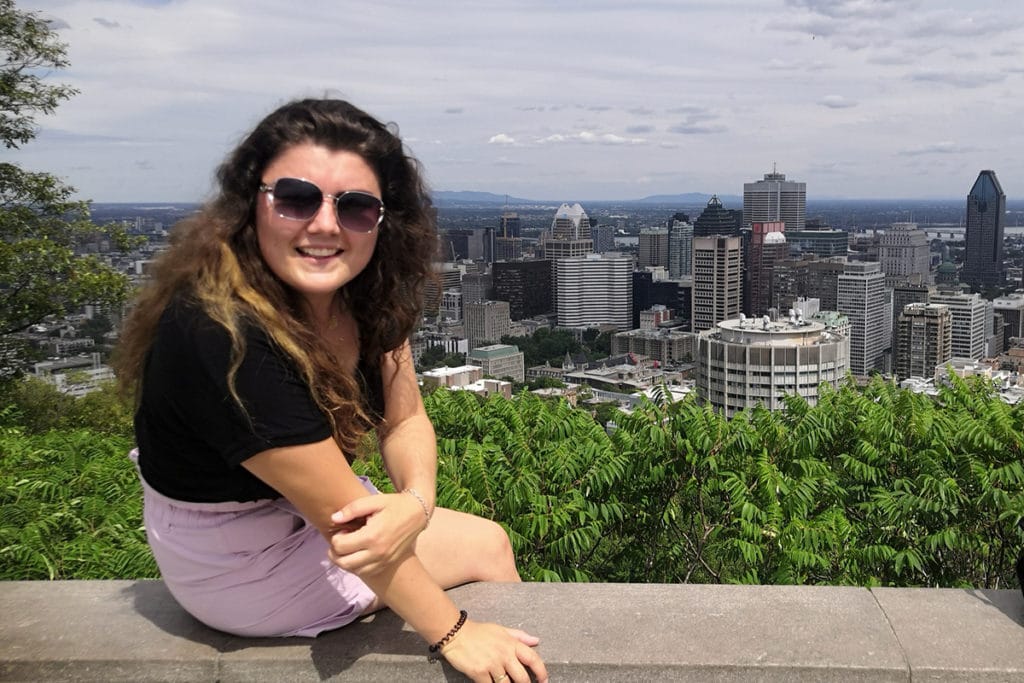 Woman smiles on top of Mount Royale in Montreal.