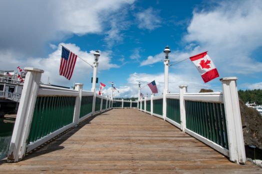 Roche Harbor - United States of America and Canada Flags Hang From the Dock