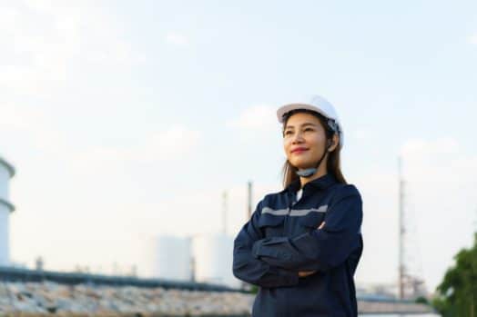 Engineer stands outside at job site.