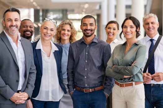 group of employees standing together smiling