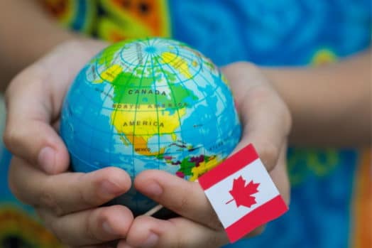 globe in hand with Canadian flag