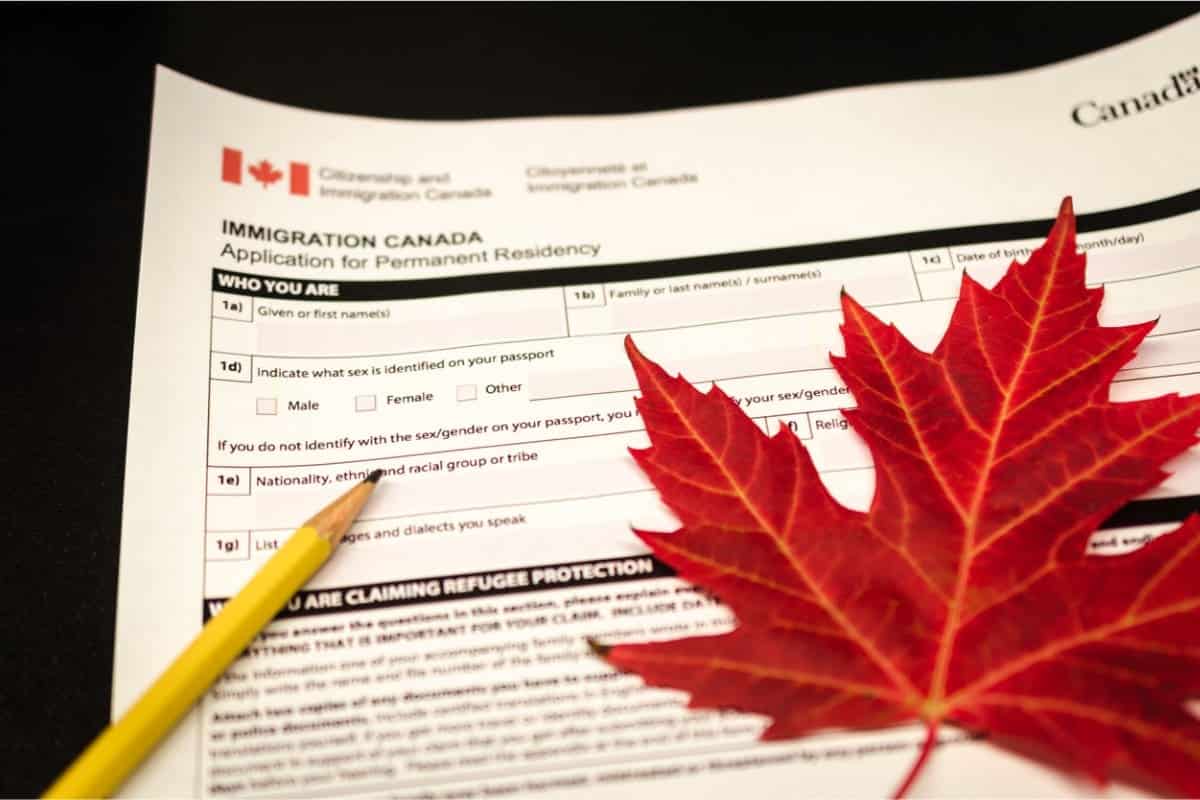 Canadian immigration application with pencil on left side and maple leaf on right side