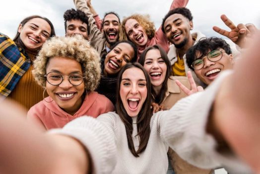 Group of multi-ethnic students smiling and taking a selfie. By 2023 Canada expects to have welcomed 750,000+ international students