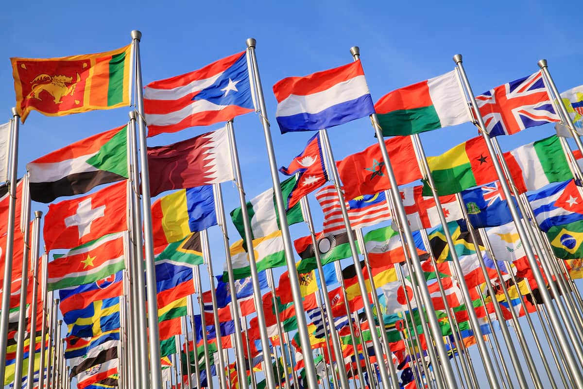 A number of countries flags flowing in the wind. Canada has free trade agreements with 51 different countries.
