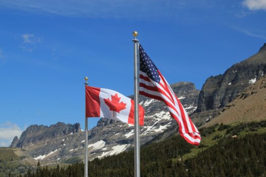 Canada and US Flags flying next to eachother