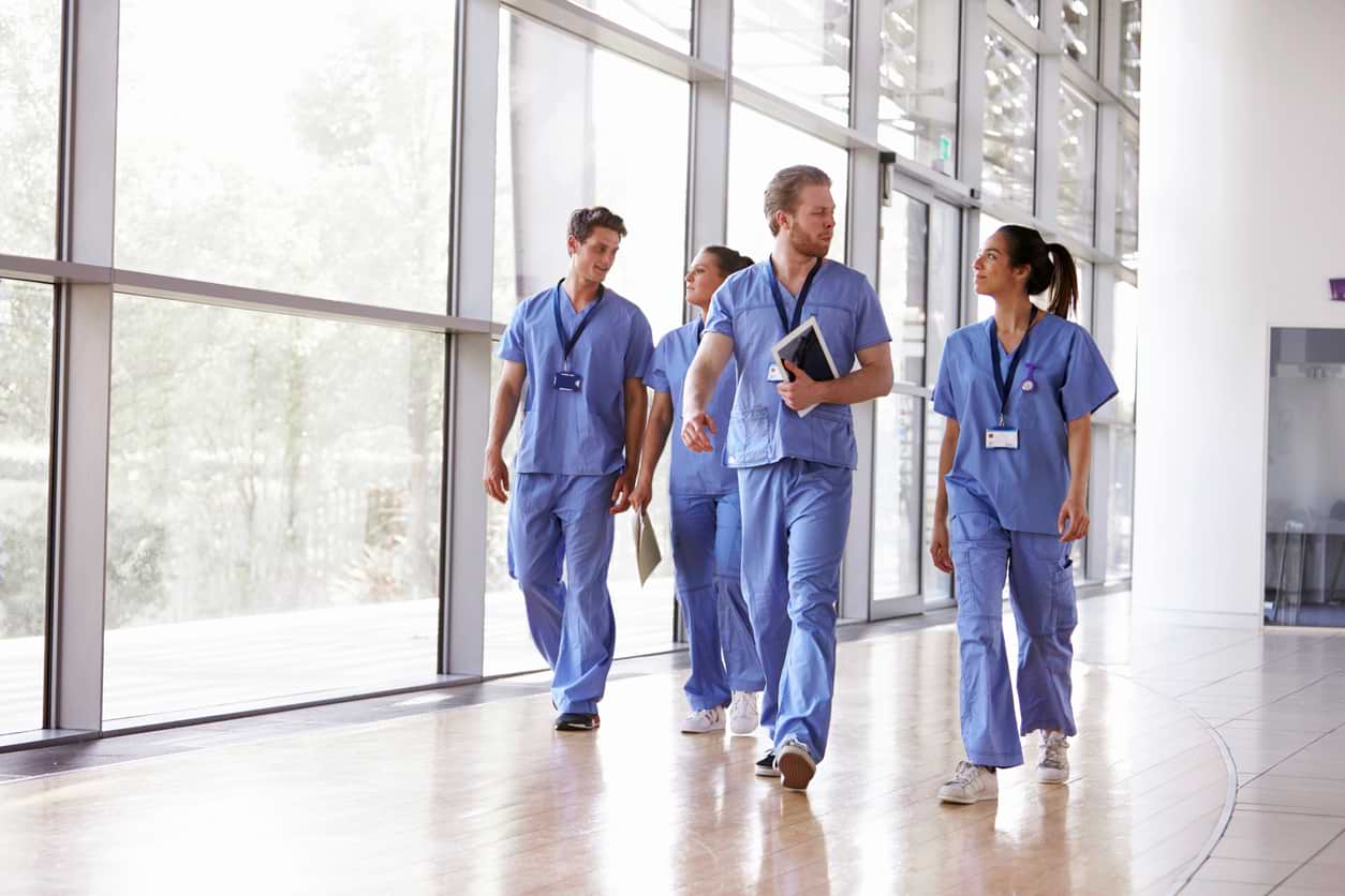 Healthcare workers walking down a hallway. Canada has experienced record high vacancies in the healthcare sectors.