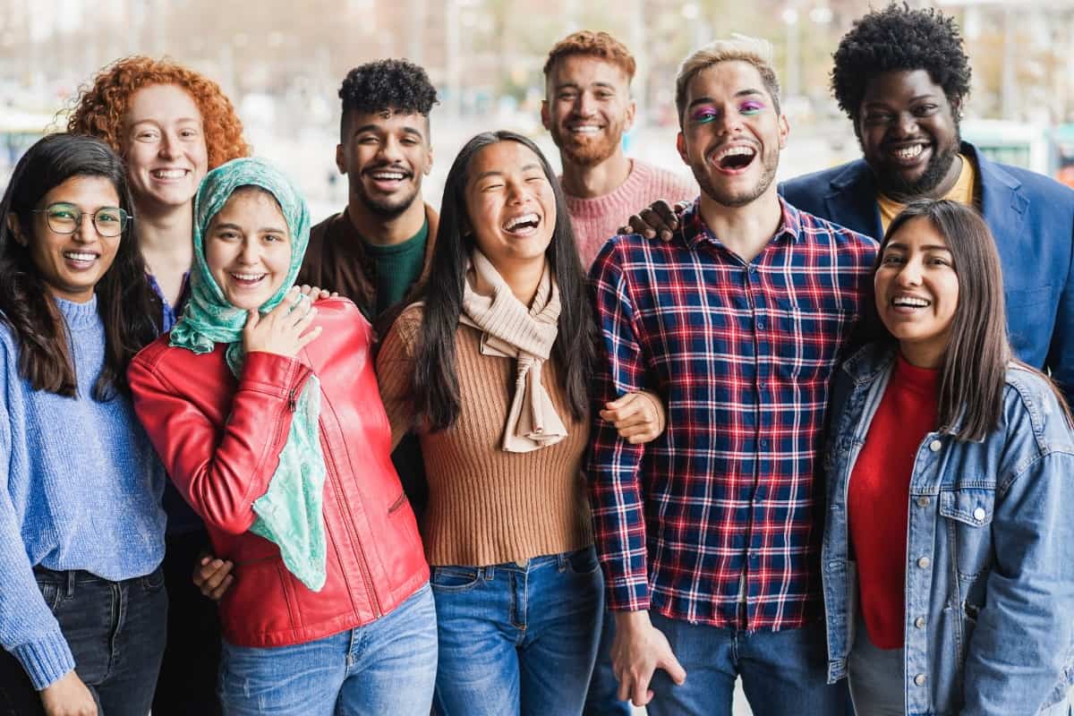 group of diverse young people standing and smiling together