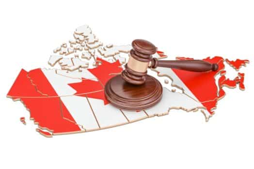 wooden gavel on map of Canada