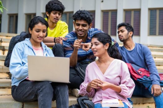 students sitting with laptop