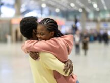Couple reunites in an airport.