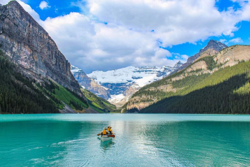 Two people riding in a canoe on Lake Louise in Banff, Alberta