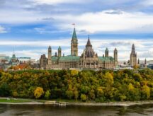 Stunning autumn view of Parliament Hill across the Ottawa River in Ottawa, Canada