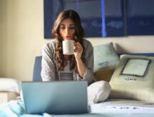 A woman sits on her bed looking at a laptop. IRCC has several channels by which applicants may contact the department about their application. Read on to learn more.