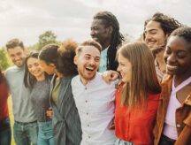 A multiracial group of friends pose for a photo together. In 2023 Canada welcomed tens of thousands of former international students as new permanent residents of the country. Read on to learn more.