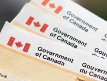 A stack of Canadian government documents waiting to be processed.