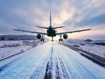 A plane flies just over an icy runway. A minority of Canadian PRs choose to leave Canada—find out why.