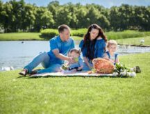 Young family with children having fun in nature on a picnic