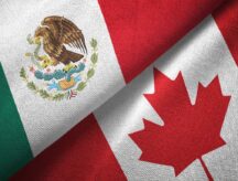A Mexican and Canadian flag together in diagonal arrangement.