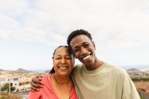 A picture of a man and his mother smiling.