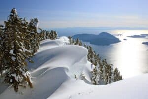 A view of the lake from snow capped mountains in British Columbia