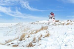 A lighthouse covered in snow on the Canadian coast.