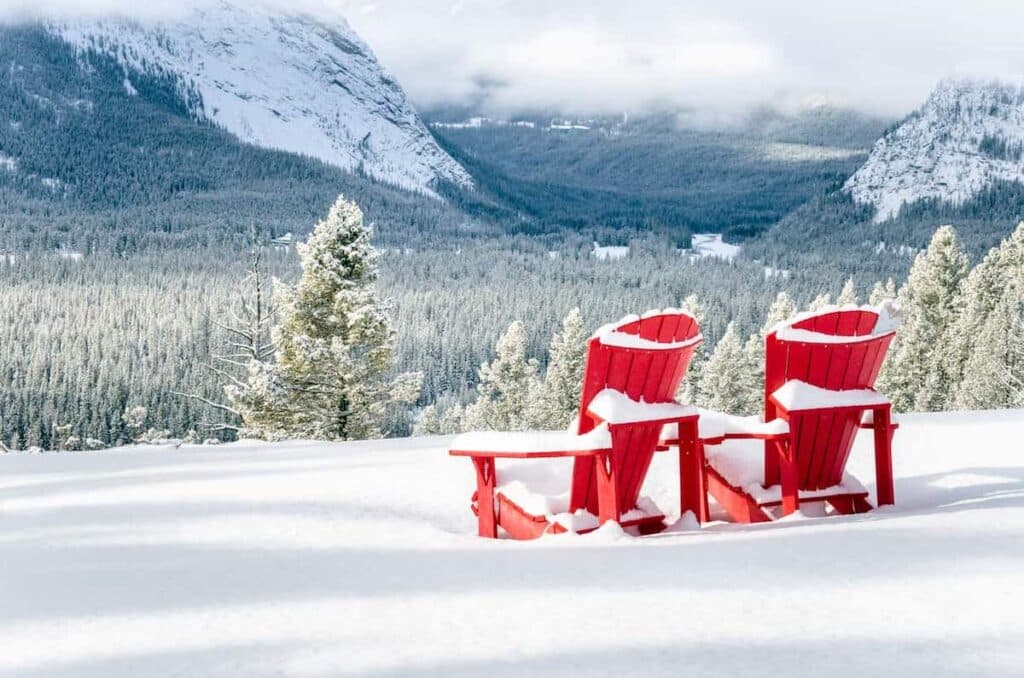 Two chairs on top of a snowy plane