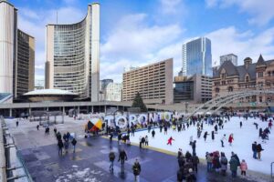 A group of people at Nathan Phillips square during the winter time.