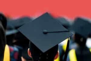 A graduate at their university graduation in ceremonial garb.