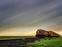 A freight train passing through the Manitoba countryside.