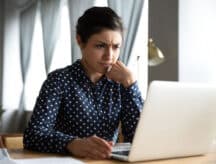 Young woman staring at laptop screen