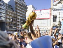 A group of football fans with a replica FIFA trophy in Qatar, for the 2022 world cup.