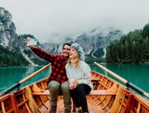 A couple at Banff takes a selfie on a boat.