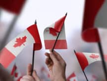 Hands holding Canadian flag