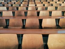 A row of empty seats in a university lecture hall.