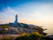 A picture of a majestic lighthouse standing on the Nova Scotia coast.